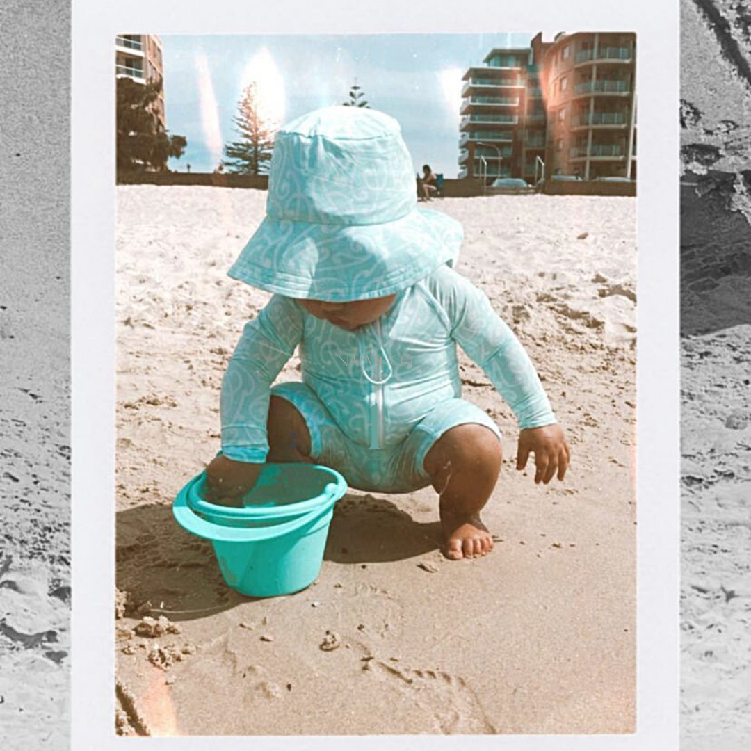 Baby in our swimwear playing at the beach
